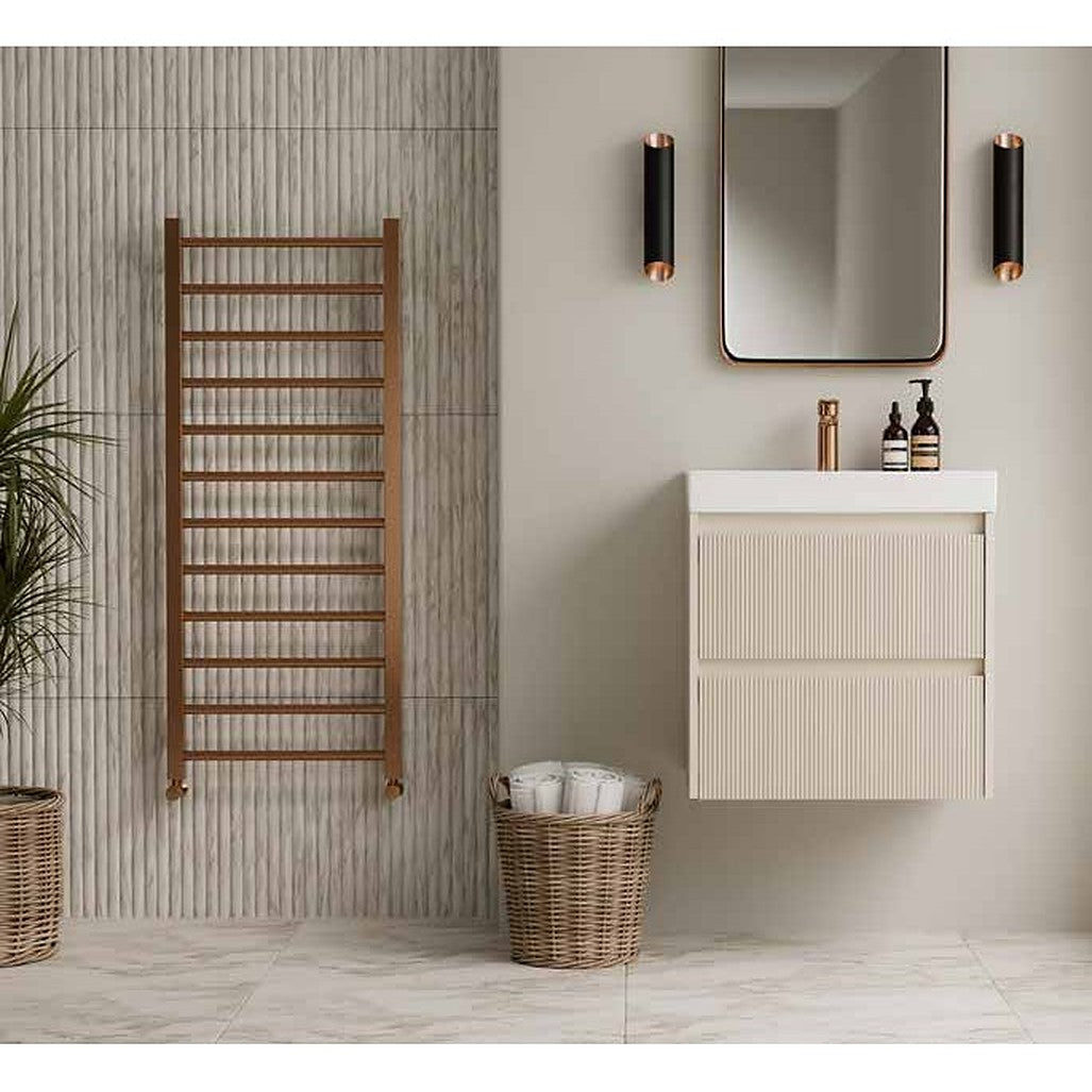 Artisa ladder towel radiator in a warm metallic finish beside a vanity unit