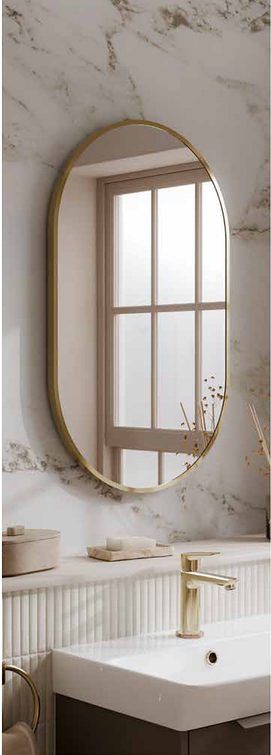 Astria oval framed mirror in brushed brass above a basin