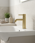 Aurea Brushed Brass Mono Basin Mixer in a bright modern bathroom
