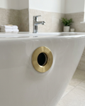 Basin Overflow Rings, brushed brass in a bright modern bathroom
