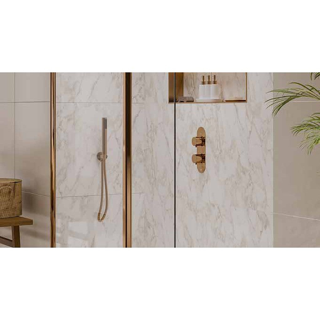 Round concealed shower valve and hand shower in a warm metallic finish