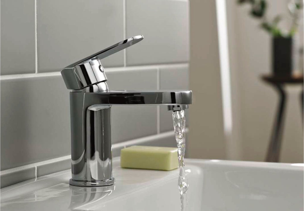 Logan taps in a bathroom