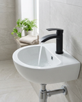 Noxa Curve Matt Black Mini Mono Basin Mixer in a bright modern bathroom