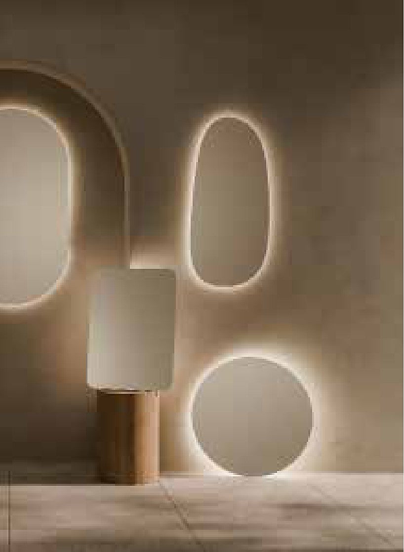 Organic backlit LED mirrors glowing on a warm plaster wall
