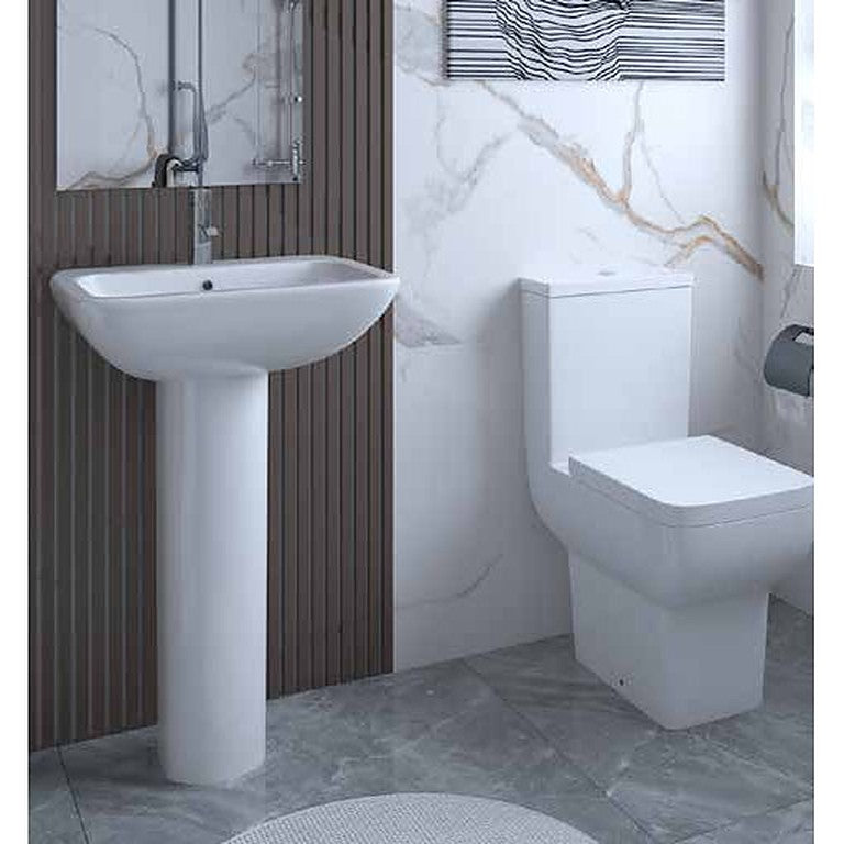 Spazio basin, pedestal and close coupled toilet in a marble-effect bathroom
